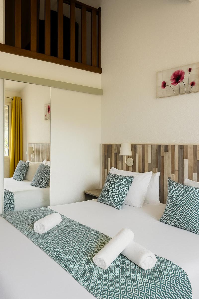 Un ou plusieurs lits dans un hébergement de l'établissement Hotel & Spa Gil de France Cap d'Agde
