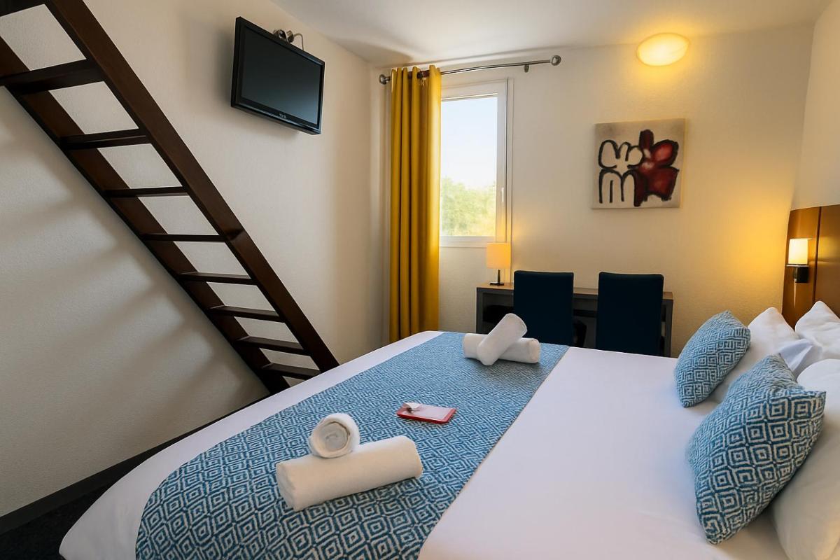 Un ou plusieurs lits dans un hébergement de l'établissement Hotel & Spa Gil de France Cap d'Agde