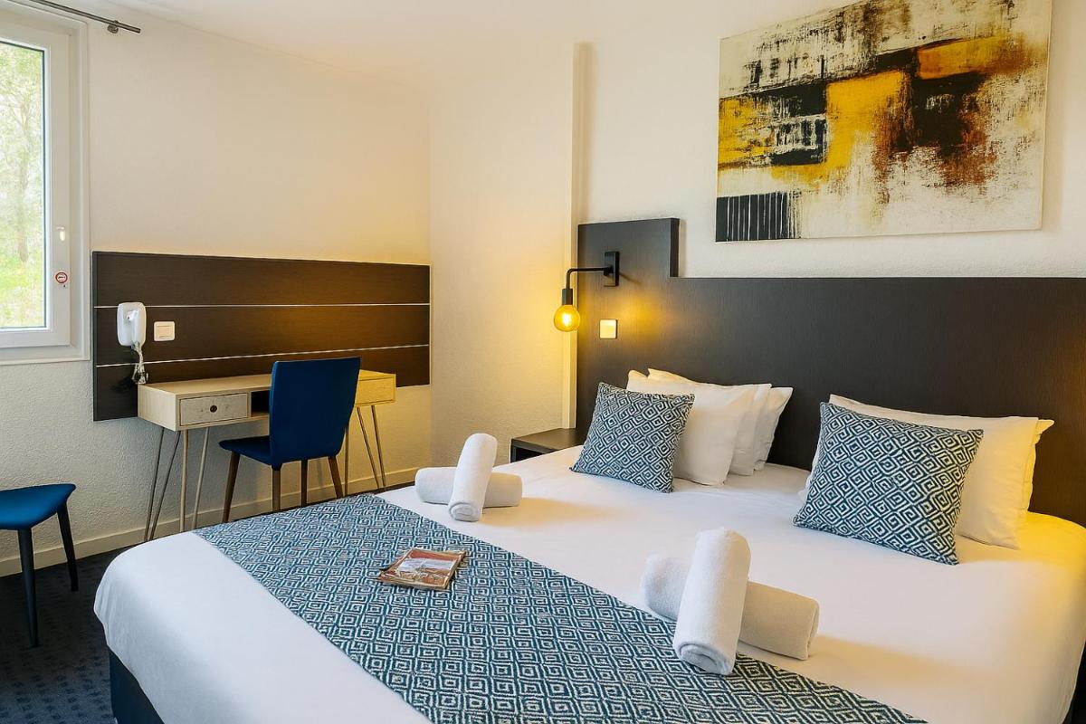 Un ou plusieurs lits dans un hébergement de l'établissement Hotel & Spa Gil de France Cap d'Agde