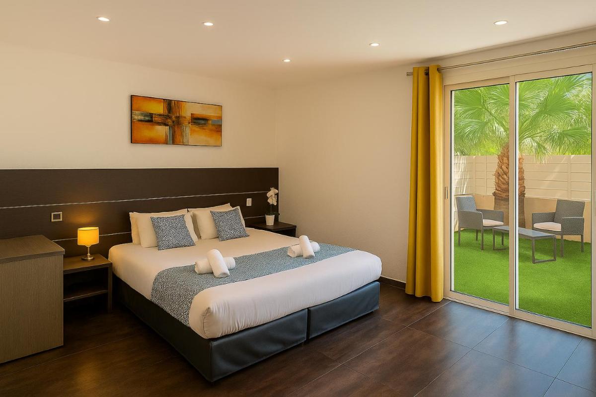 Un ou plusieurs lits dans un hébergement de l'établissement Hotel & Spa Gil de France Cap d'Agde