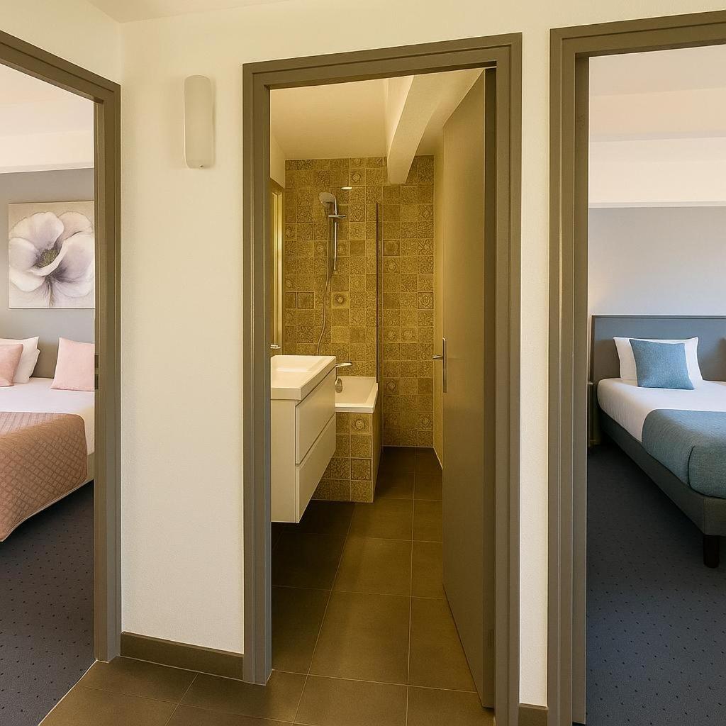 Un ou plusieurs lits dans un hébergement de l'établissement Hotel & Spa Gil de France Cap d'Agde