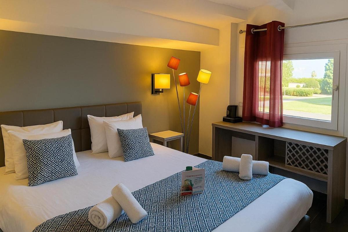 Un ou plusieurs lits dans un hébergement de l'établissement Hotel & Spa Gil de France Cap d'Agde