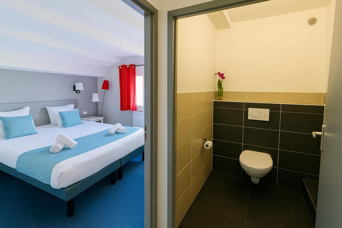 Un ou plusieurs lits dans un hébergement de l'établissement Hotel & Spa Gil de France Cap d'Agde