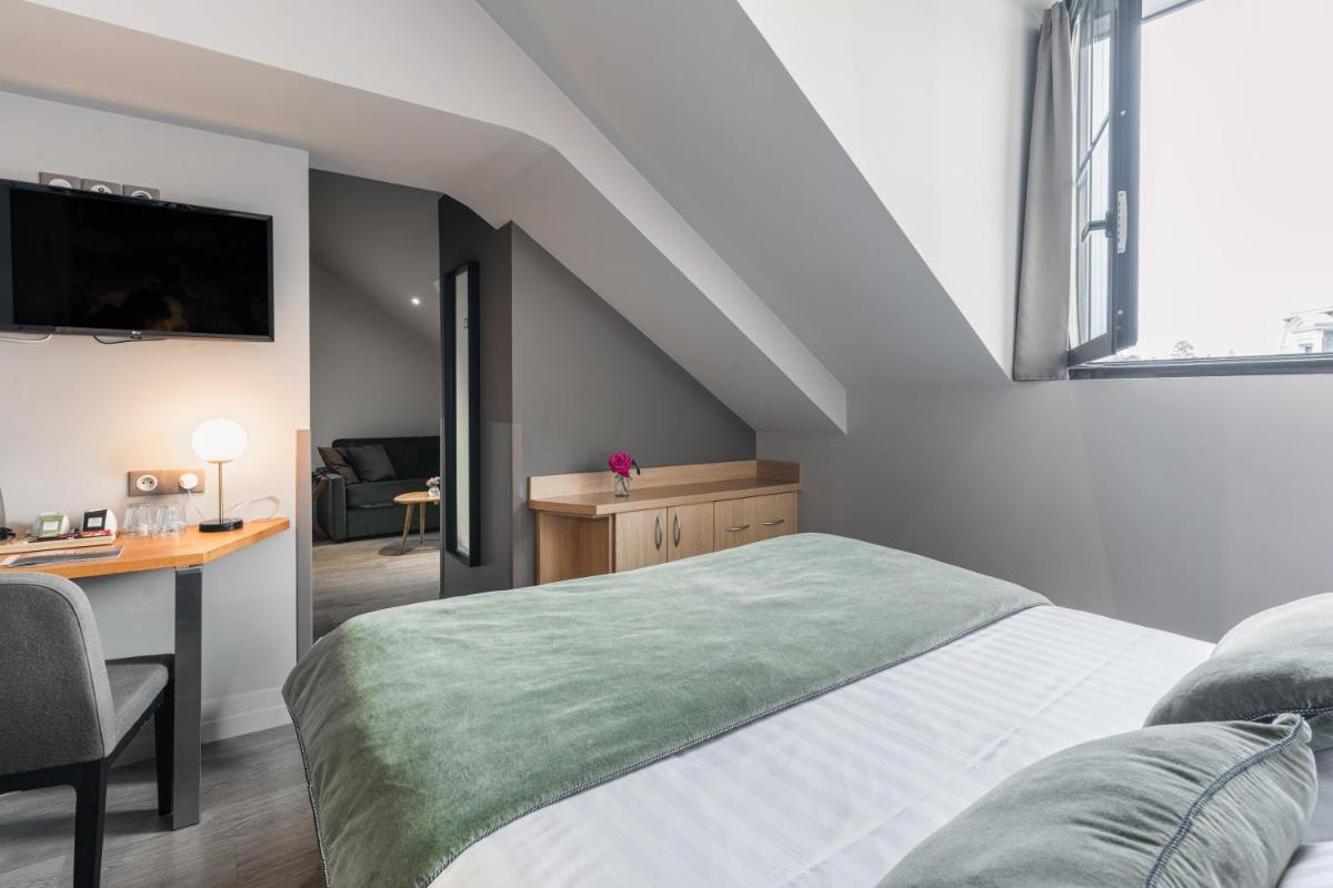 Un ou plusieurs lits dans un hébergement de l'établissement Edgar Hôtel & Spa - Table Gastronomique