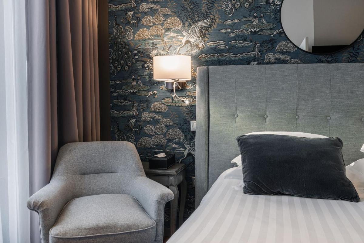Un ou plusieurs lits dans un hébergement de l'établissement Edgar Hôtel & Spa - Table Gastronomique