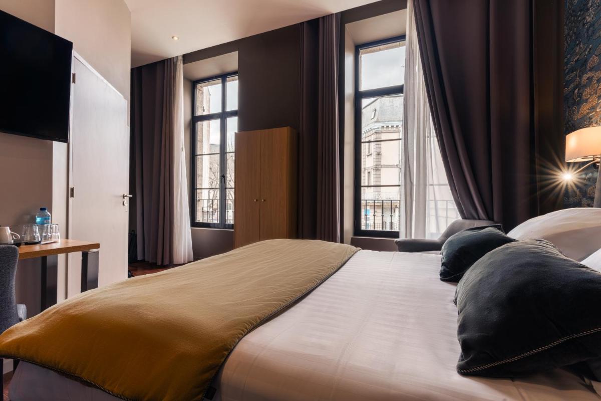 Un ou plusieurs lits dans un hébergement de l'établissement Edgar Hôtel & Spa - Table Gastronomique