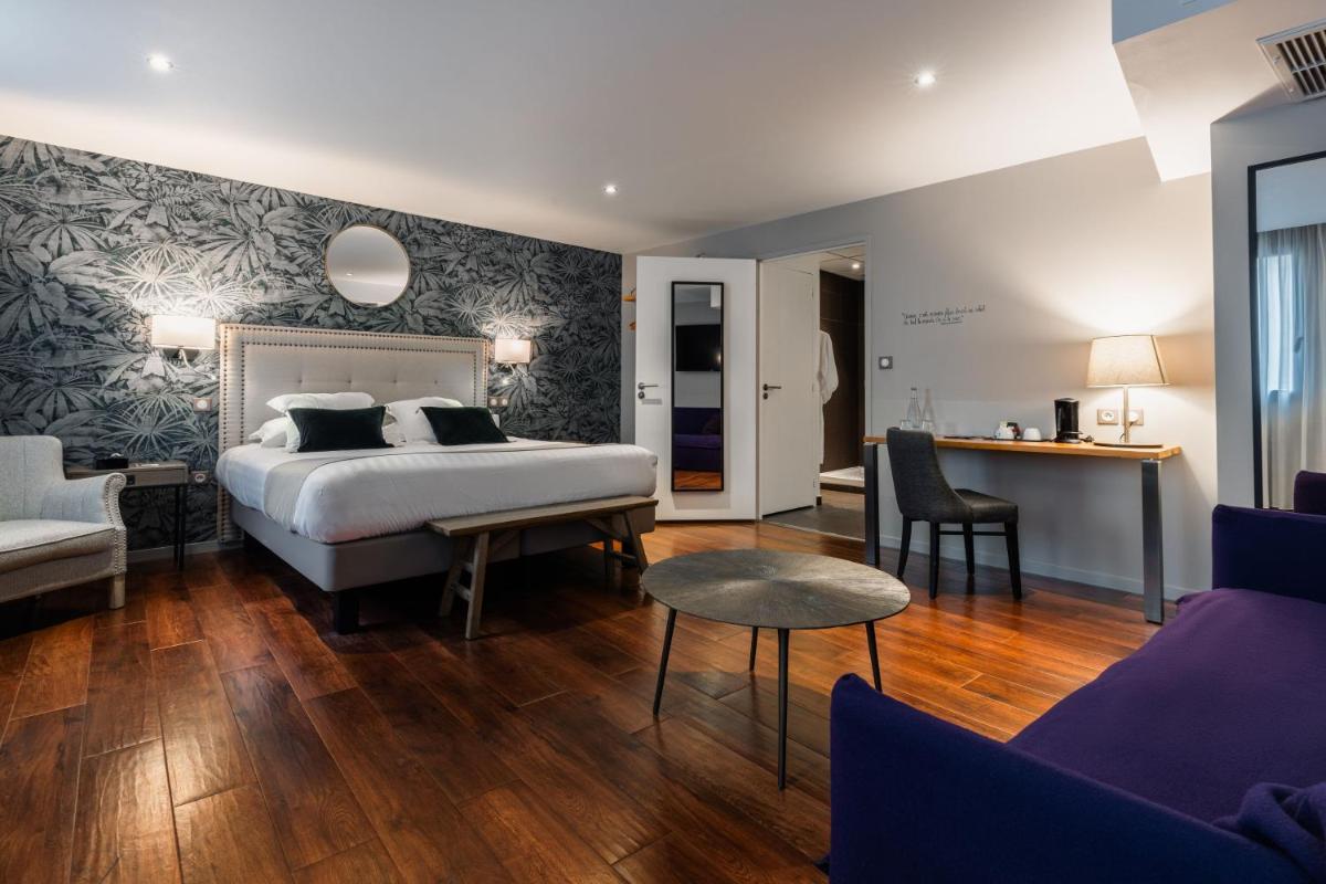 Un ou plusieurs lits dans un hébergement de l'établissement Edgar Hôtel & Spa - Table Gastronomique