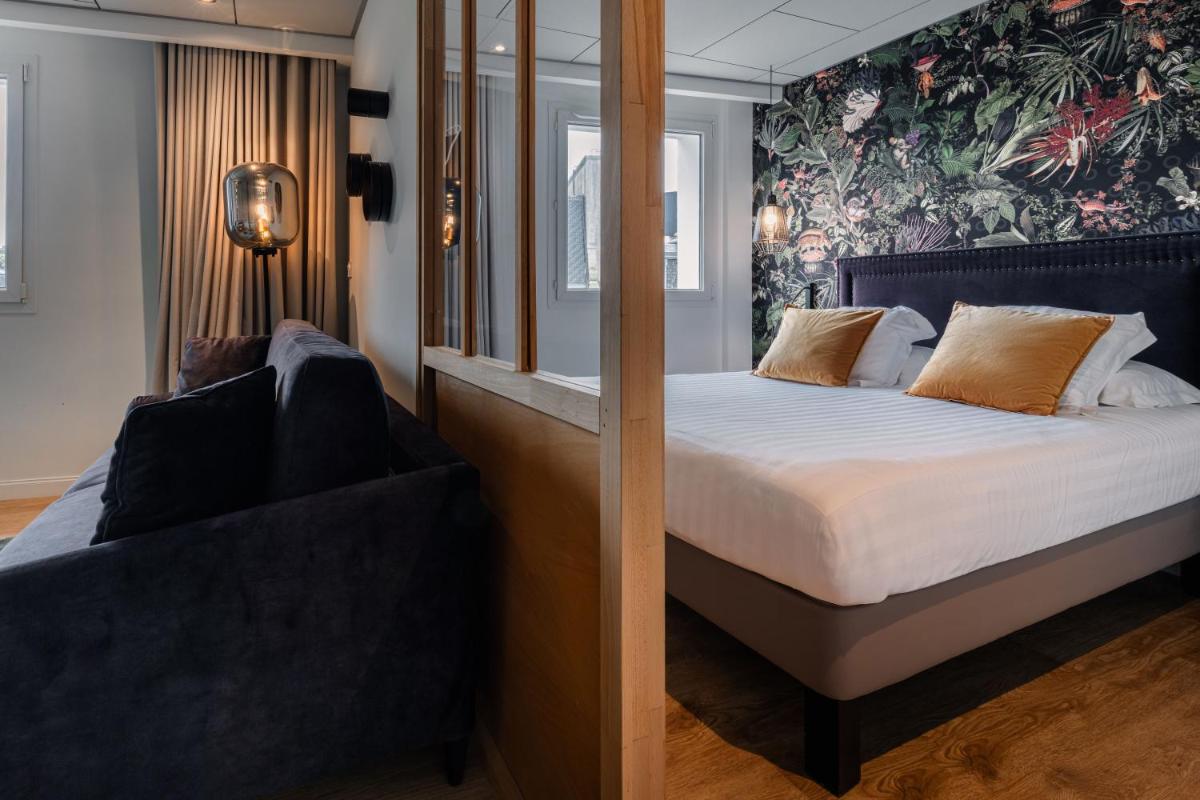 Un ou plusieurs lits dans un hébergement de l'établissement Edgar Hôtel & Spa - Table Gastronomique