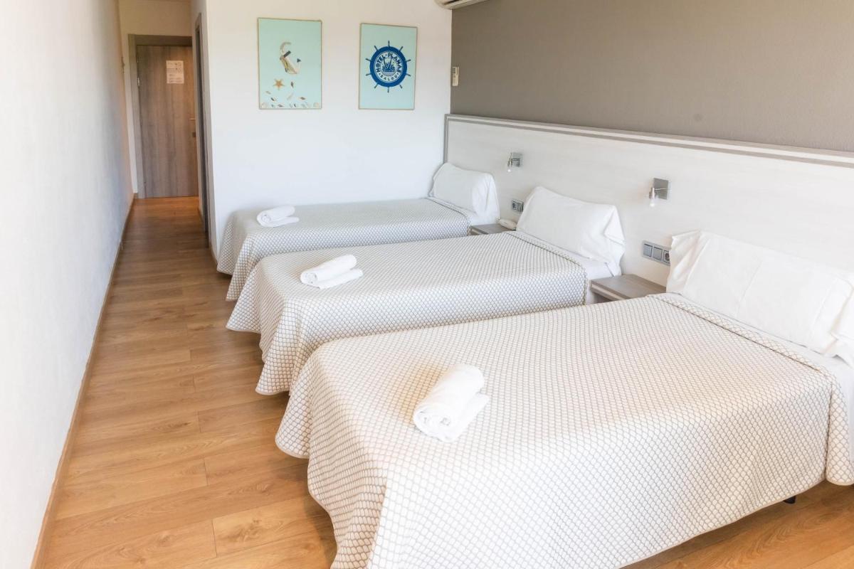 Cama o camas de una habitación en Hotel Planas