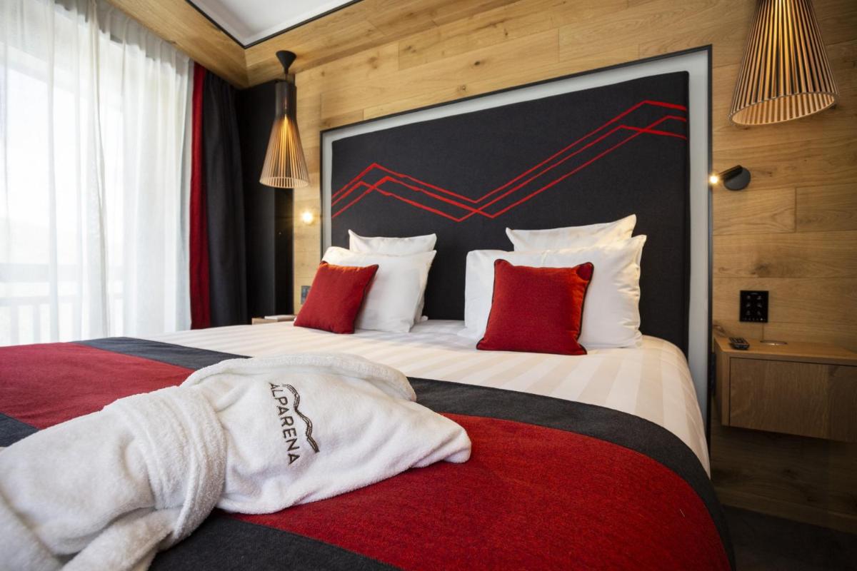 Un ou plusieurs lits dans un hébergement de l'établissement Hôtel Alparena & Spa - 4 étoiles