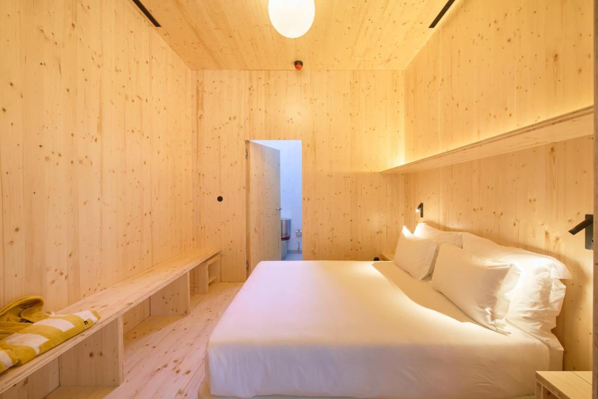 Uma cama ou camas num quarto em Moagem Industrial Lodge