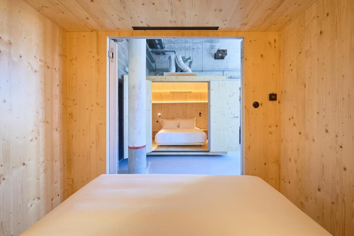 Uma cama ou camas num quarto em Moagem Industrial Lodge