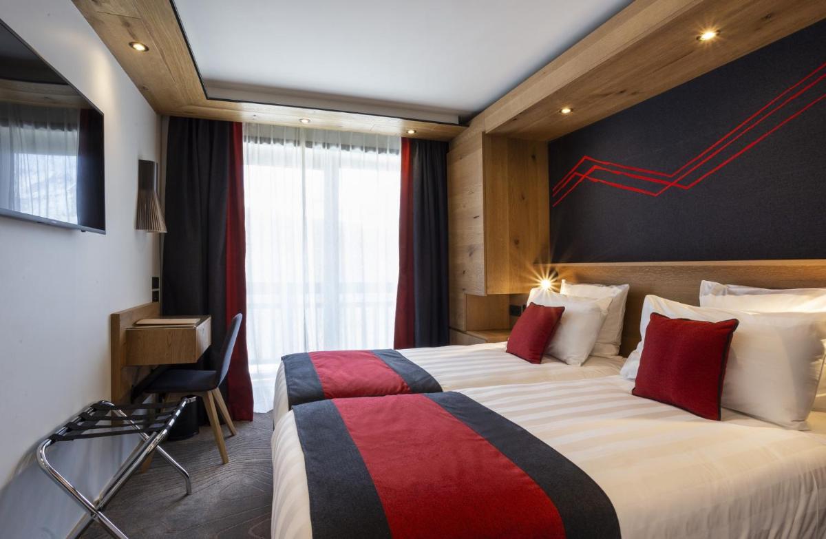 Un ou plusieurs lits dans un hébergement de l'établissement Hôtel Alparena & Spa - 4 étoiles