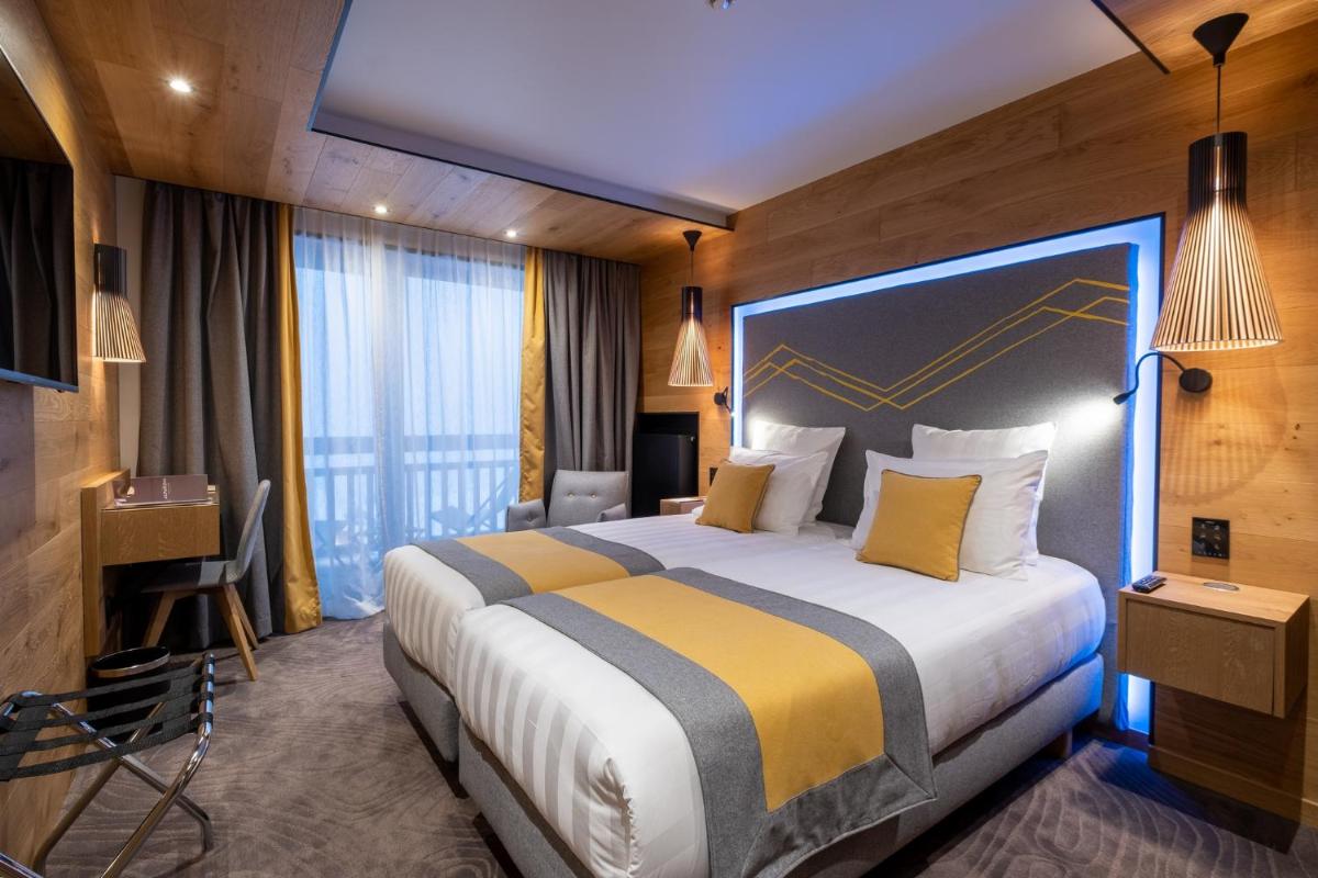 Un ou plusieurs lits dans un hébergement de l'établissement Hôtel Alparena & Spa - 4 étoiles