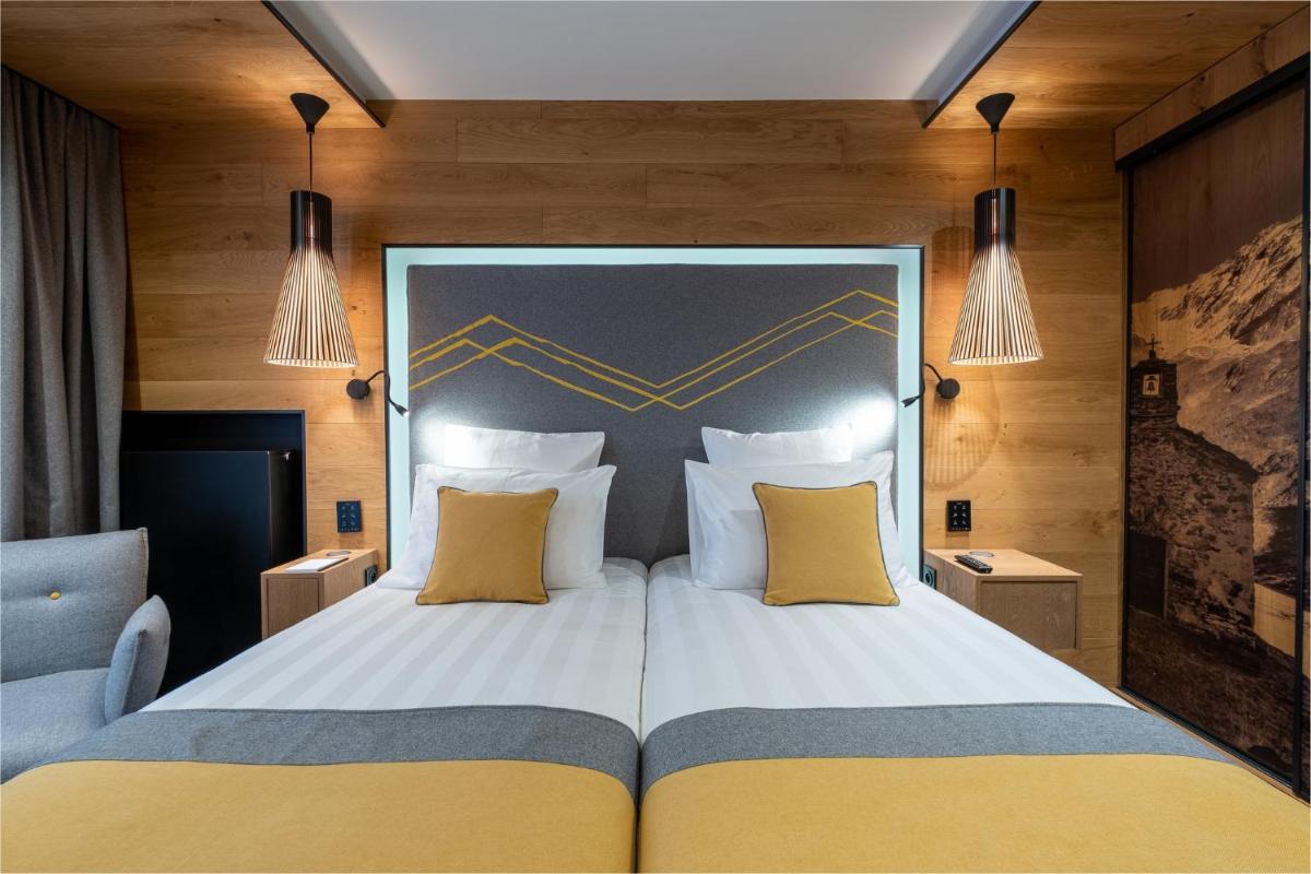 Un ou plusieurs lits dans un hébergement de l'établissement Hôtel Alparena & Spa - 4 étoiles