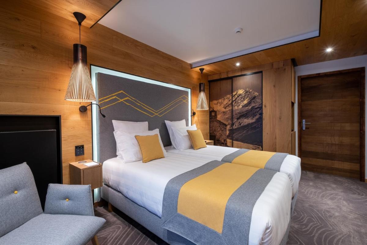 Un ou plusieurs lits dans un hébergement de l'établissement Hôtel Alparena & Spa - 4 étoiles