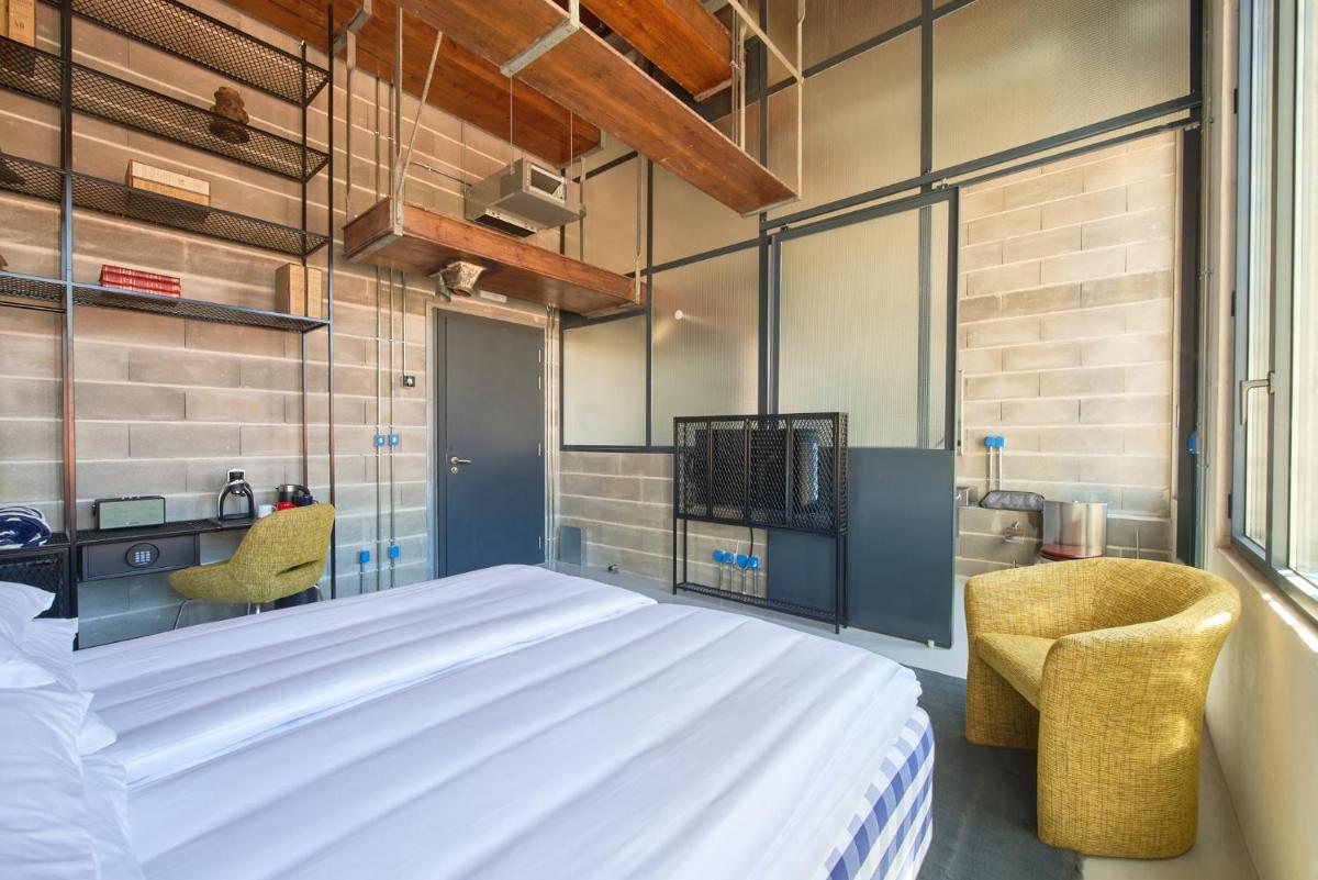 Uma cama ou camas num quarto em Moagem Industrial Lodge