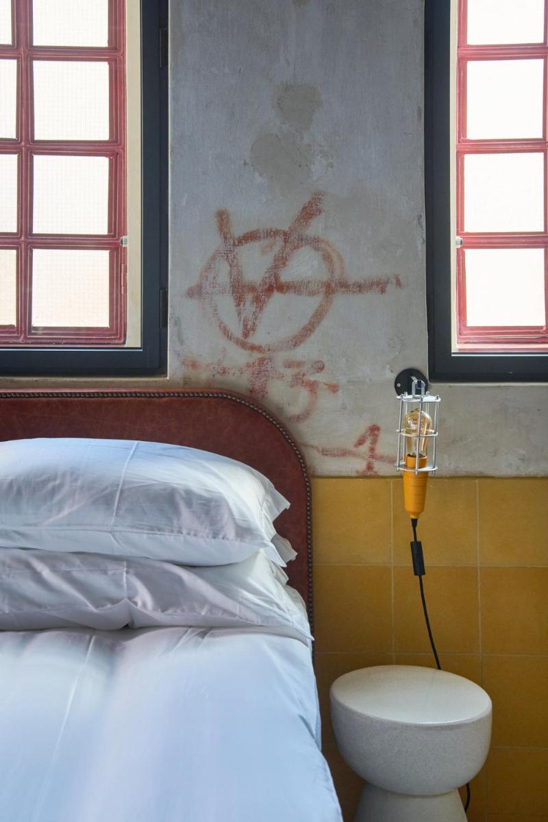 Uma cama ou camas num quarto em Moagem Industrial Lodge