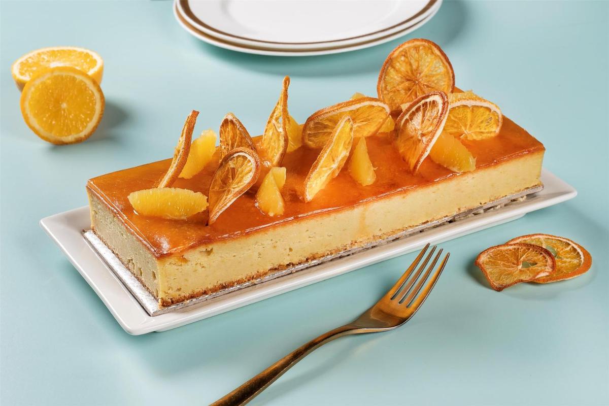 a piece of orange cheesecake on a plate with a fork at Radisson Blu Hotel New Delhi Dwarka in New Delhi a piece of orange cheesecake on a plate with a fork at Radisson Blu Hotel New Delhi Dwarka in New Delhi