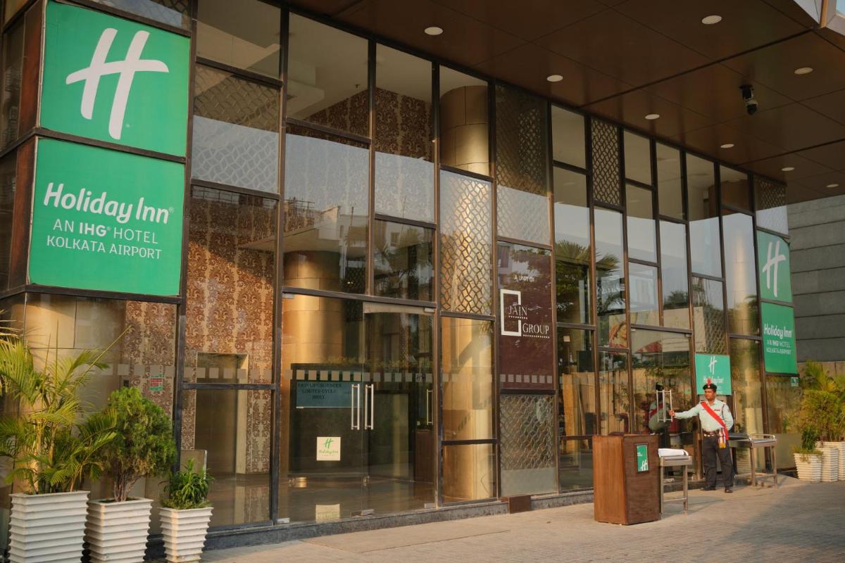 a building with a sign on the front of it at Holiday Inn Kolkata Airport by IHG in Kolkata
