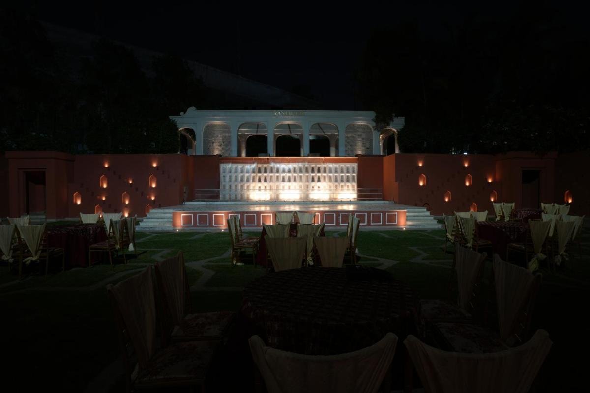 a night view of a building with chairs and lights at Clarks Avadh in Lucknow