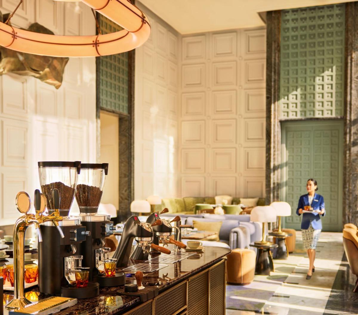 a hotel lobby with a woman standing in the background at Four Seasons Hotel Mumbai in Mumbai