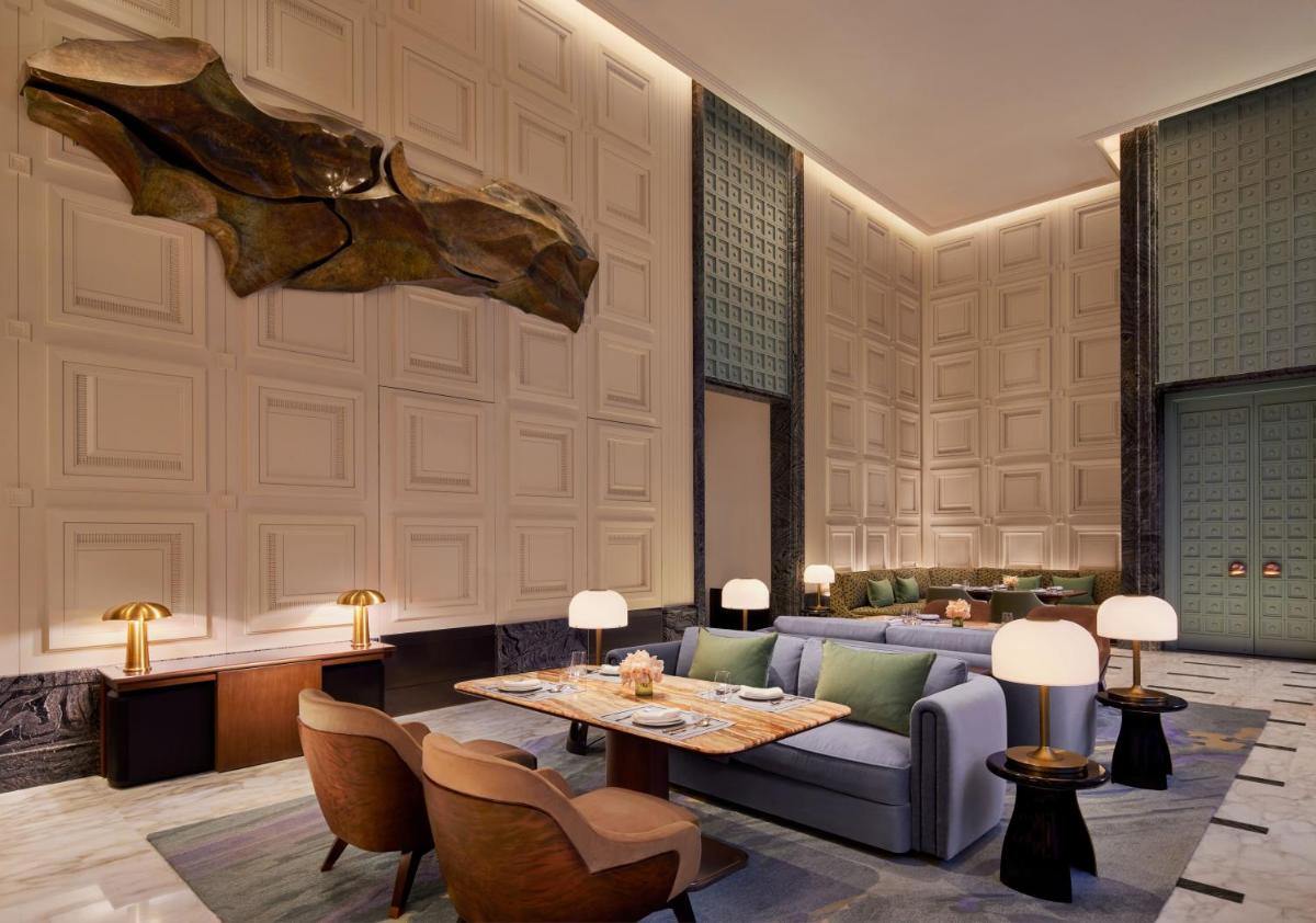 a living room with a couch and a table at Four Seasons Hotel Mumbai in Mumbai