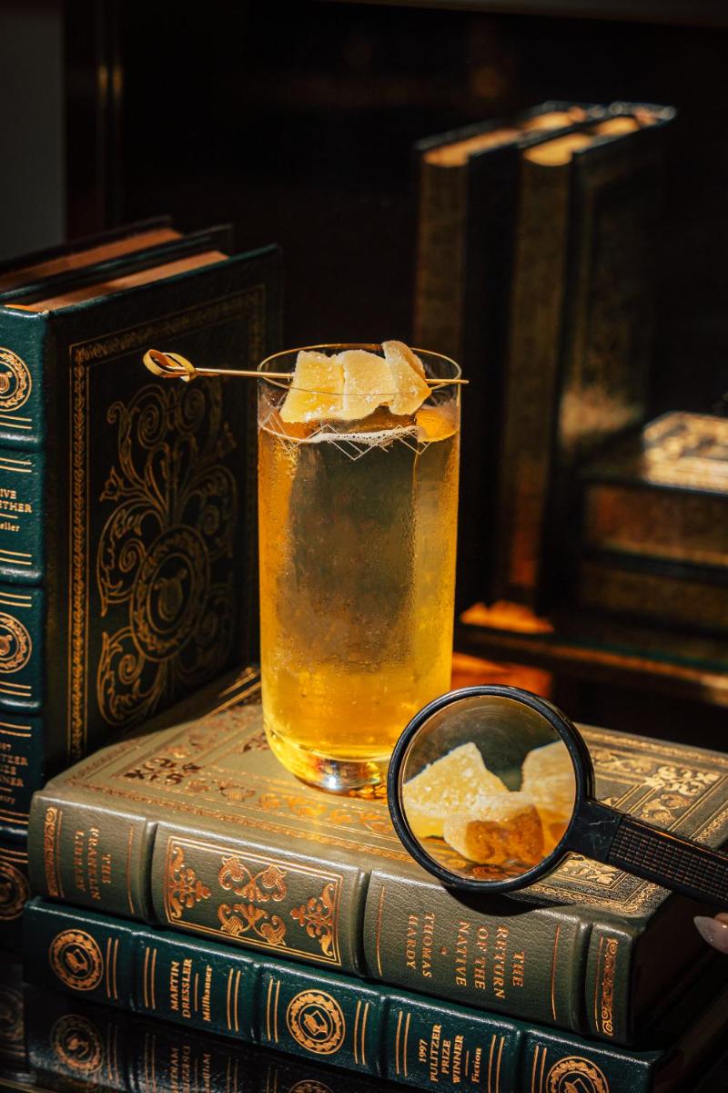 a glass of beer sitting on top of books at Four Seasons Hotel Mumbai in Mumbai