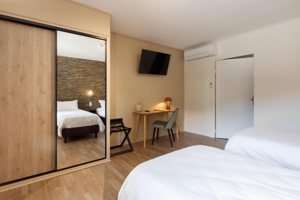 Un ou plusieurs lits dans un hébergement de l'établissement Auberge Val Moureze Hôtel & Spa
