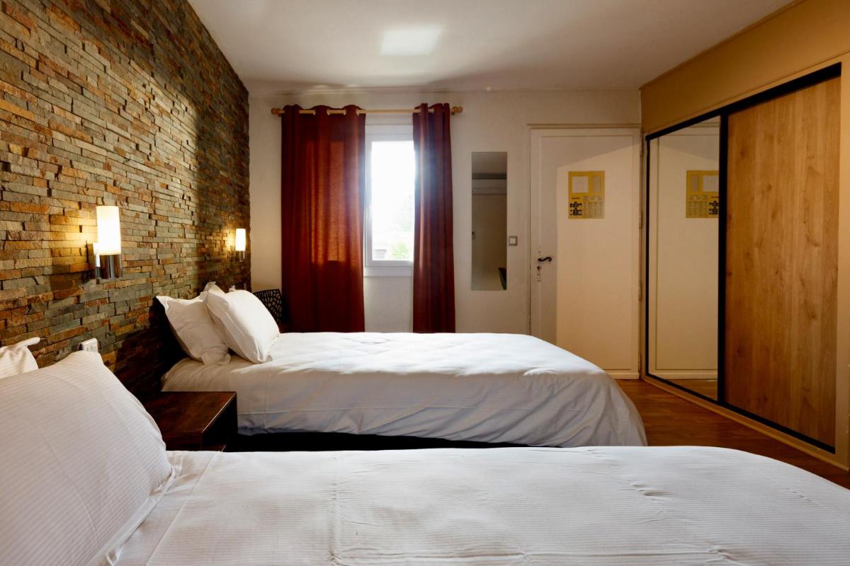 Un ou plusieurs lits dans un hébergement de l'établissement Auberge Val Moureze Hôtel & Spa