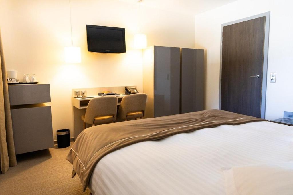 Un ou plusieurs lits dans un hébergement de l'établissement Hôtel L'Etang du Moulin By Céline