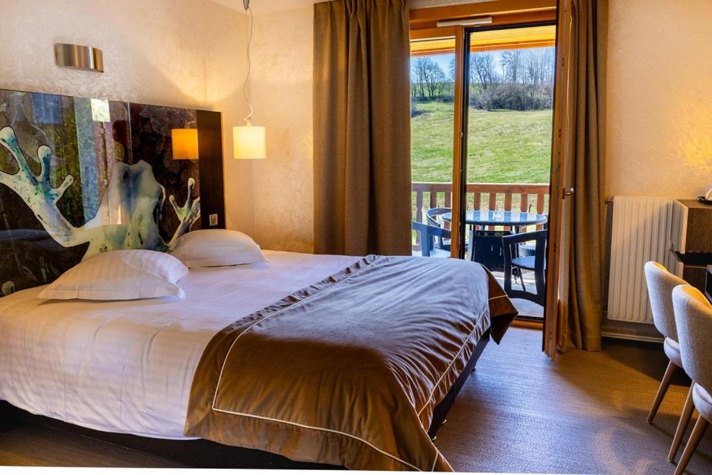 Un ou plusieurs lits dans un hébergement de l'établissement Hôtel L'Etang du Moulin By Céline