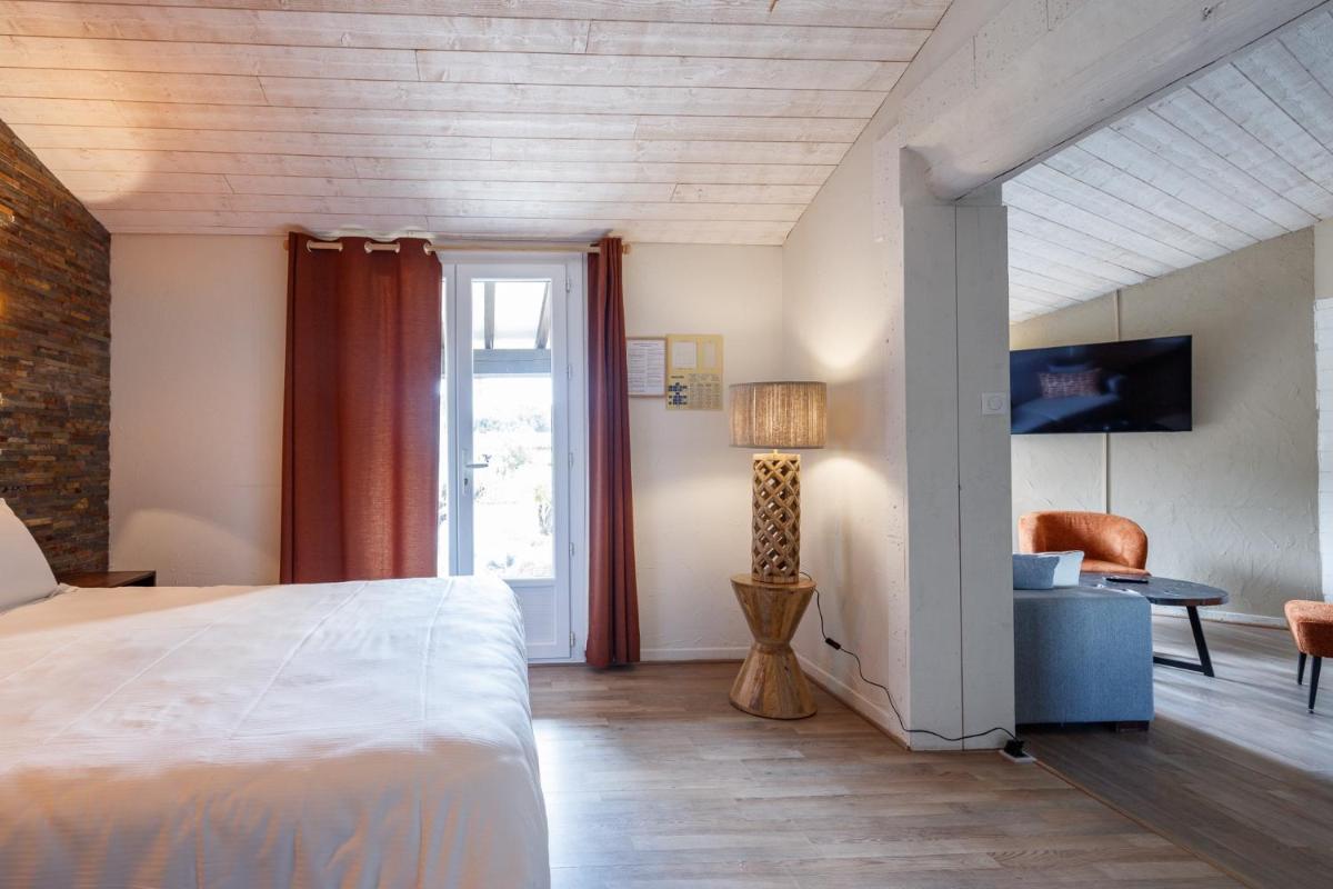 Un ou plusieurs lits dans un hébergement de l'établissement Auberge Val Moureze Hôtel & Spa