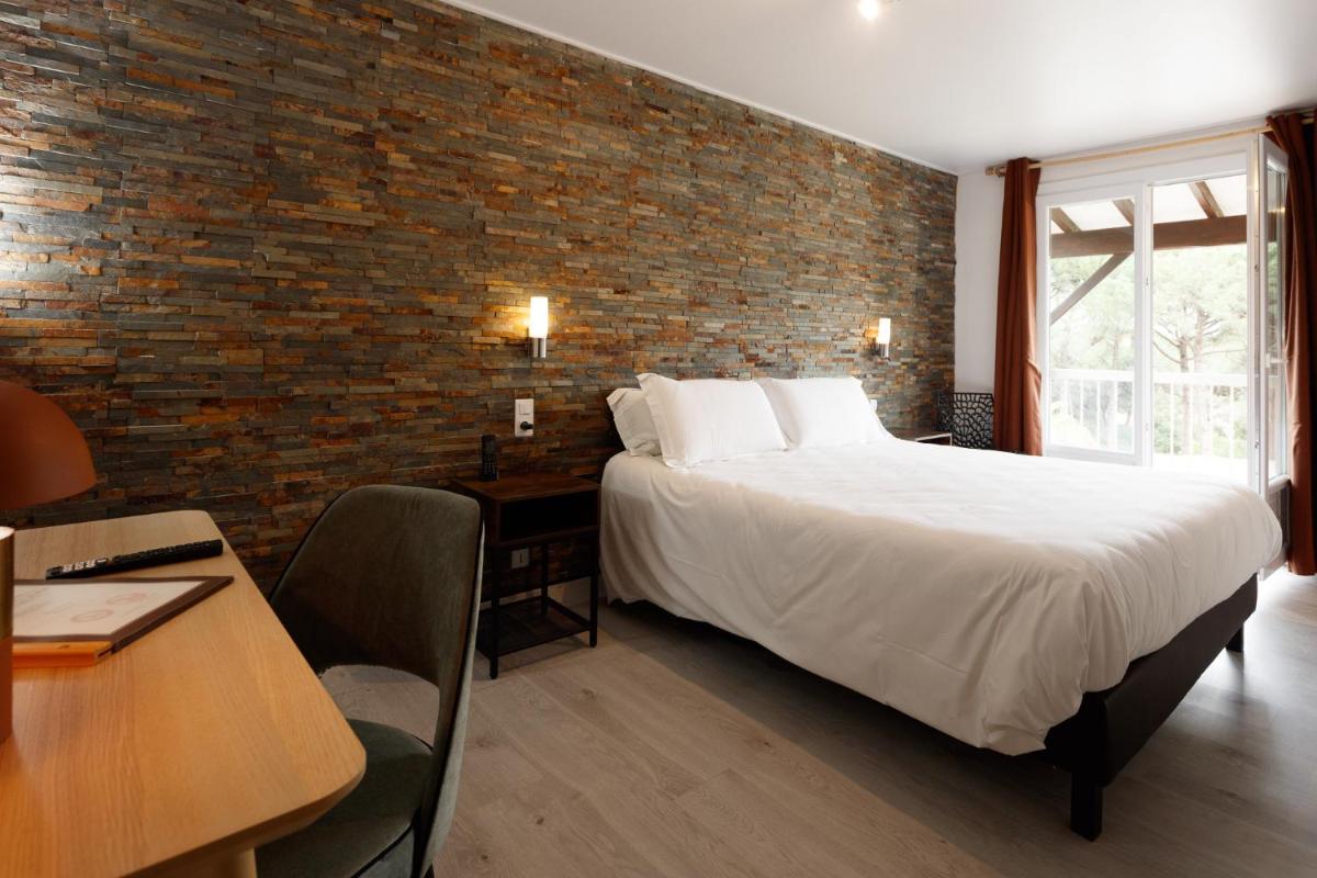 Un ou plusieurs lits dans un hébergement de l'établissement Auberge Val Moureze Hôtel & Spa
