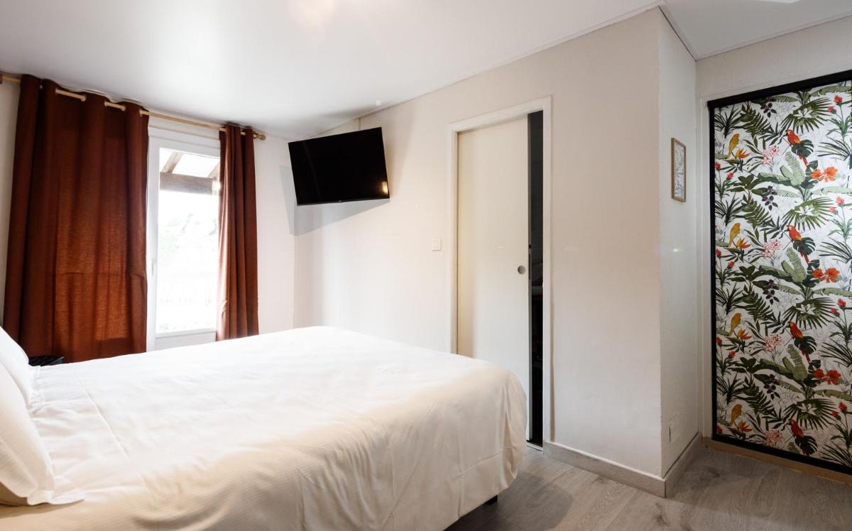 Un ou plusieurs lits dans un hébergement de l'établissement Auberge Val Moureze Hôtel & Spa