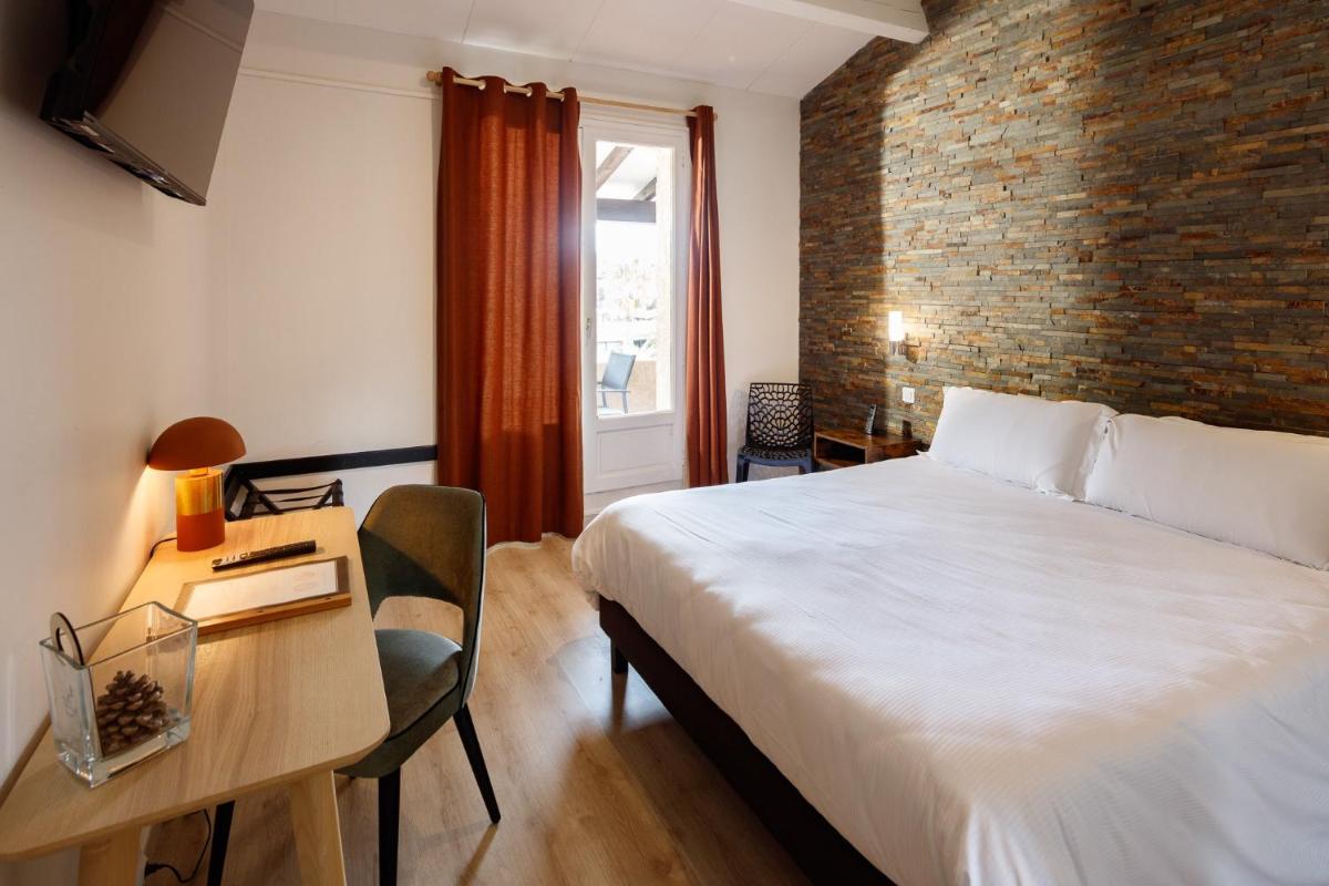 Un ou plusieurs lits dans un hébergement de l'établissement Auberge Val Moureze Hôtel & Spa