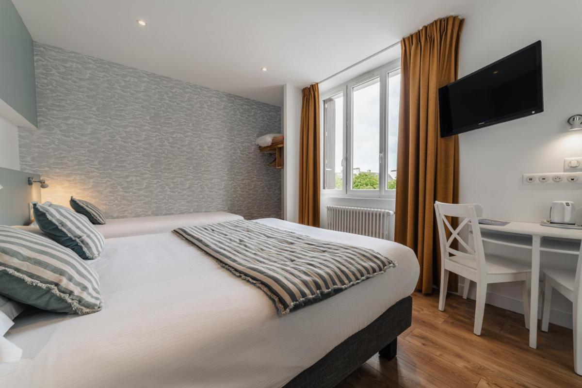 Un ou plusieurs lits dans un hébergement de l'établissement Hôtel Spa De La Citadelle Lorient