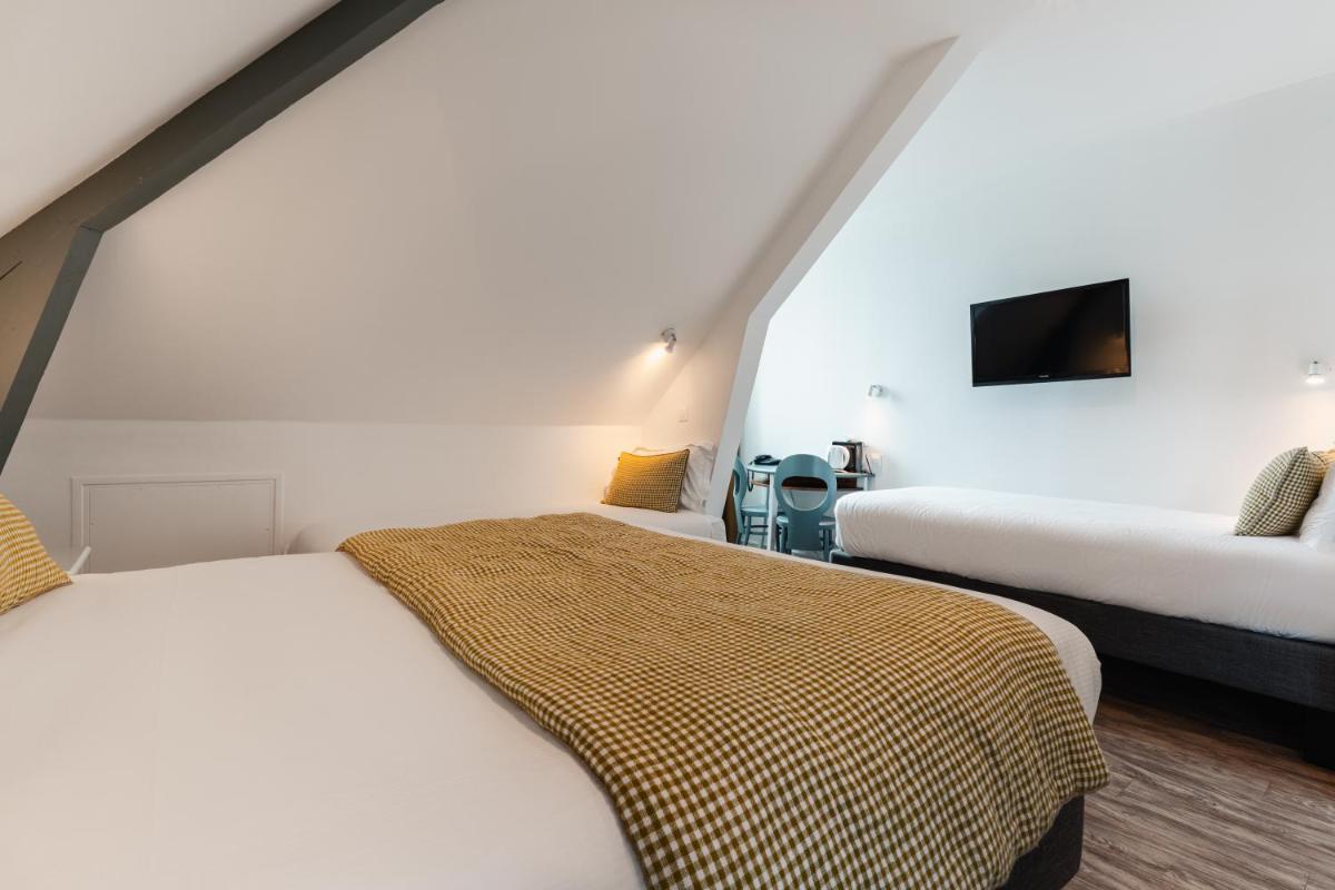 Un ou plusieurs lits dans un hébergement de l'établissement Hôtel Spa De La Citadelle Lorient