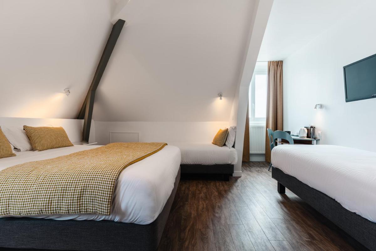 Un ou plusieurs lits dans un hébergement de l'établissement Hôtel Spa De La Citadelle Lorient