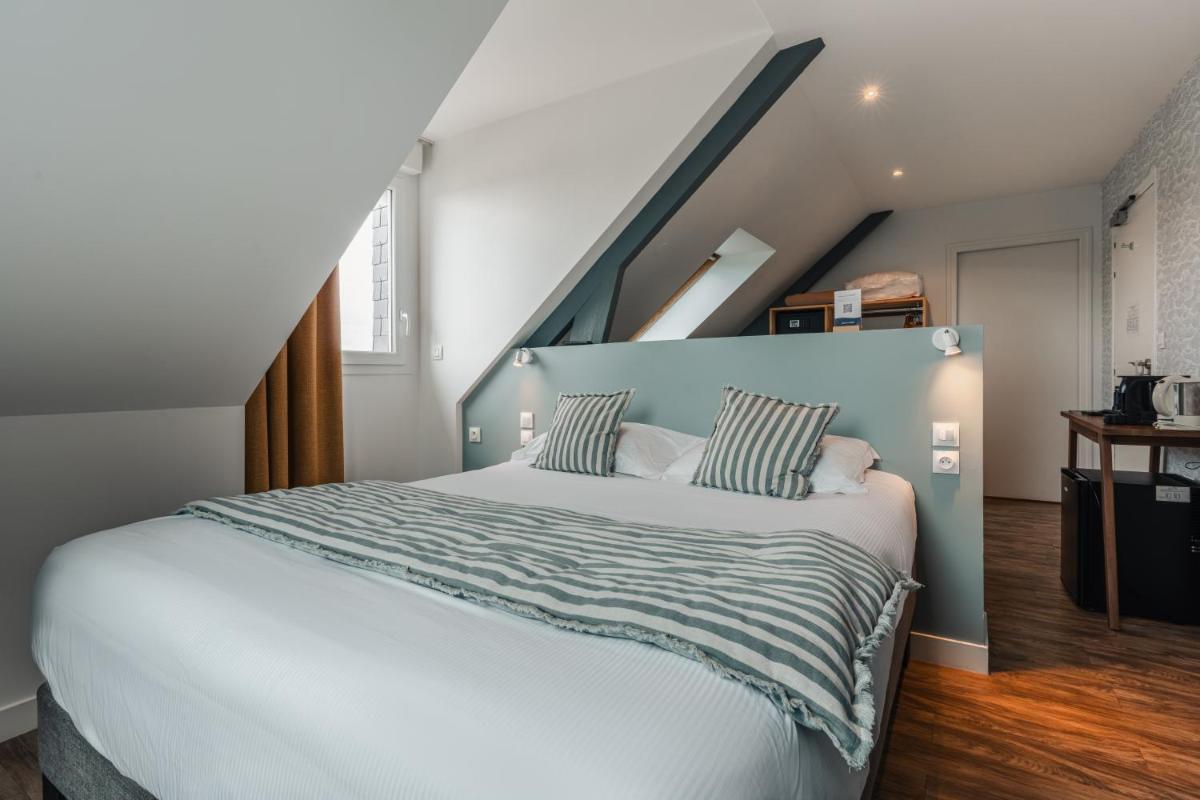 Un ou plusieurs lits dans un hébergement de l'établissement Hôtel Spa De La Citadelle Lorient