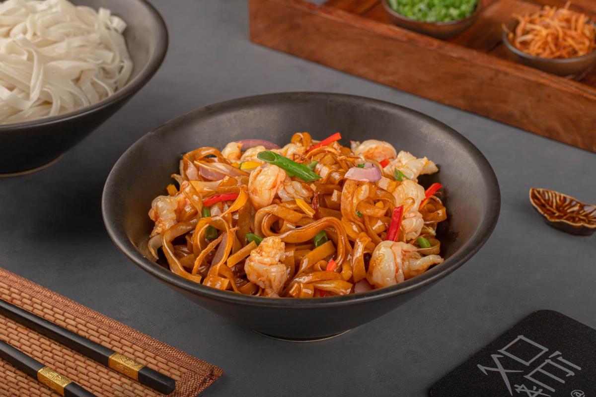 a bowl of food with shrimp and vegetables on a table at Le Meridien New Delhi in New Delhi a bowl of food with shrimp and vegetables on a table at Le Meridien New Delhi in New Delhi