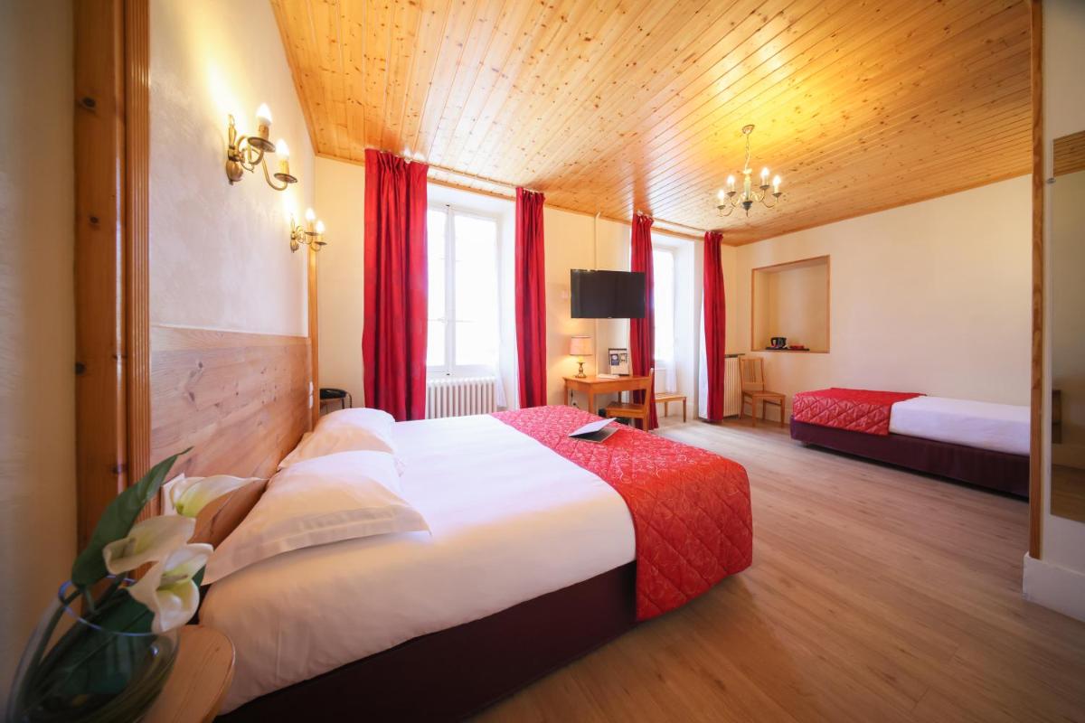 une chambre d'hôtel avec un grand lit et des rideaux rouges dans l'établissement Best Western Grand Hotel de Paris & Spa, à Villard-de-Lans 85 autres photos