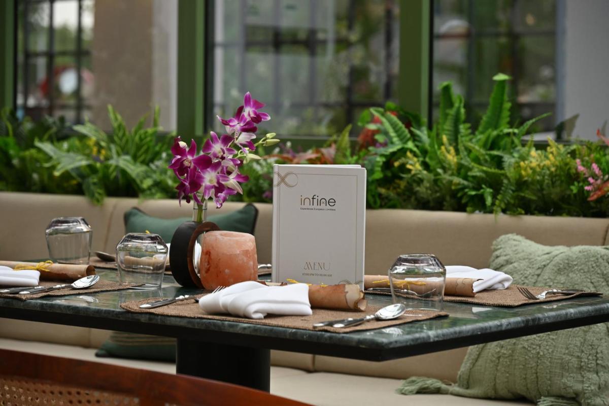 a table with a table set up for a meal at Novotel Ahmedabad in Ahmedabad