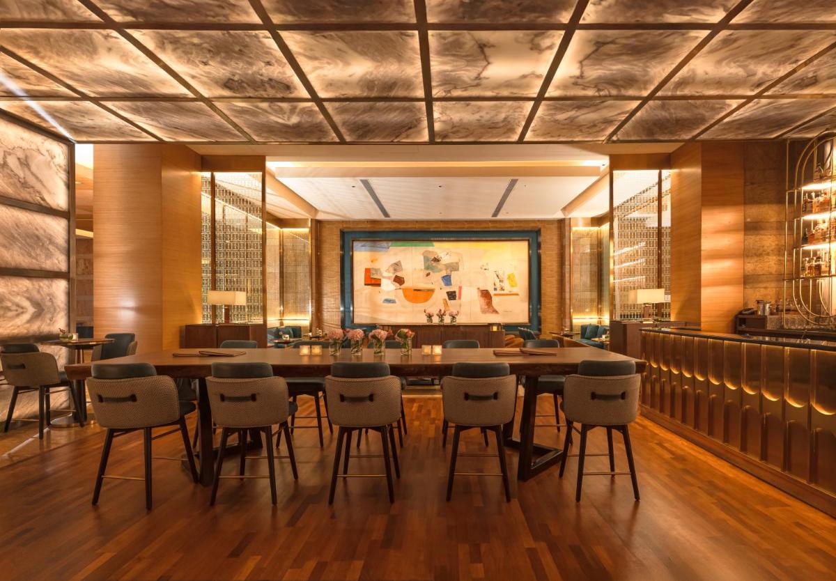 a large dining room with a large table and chairs at Grand Hyatt Mumbai Hotel and Residences in Mumbai
