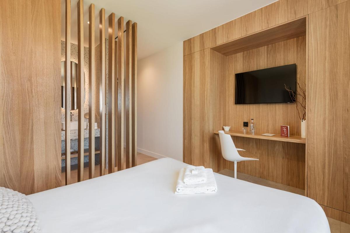 Un ou plusieurs lits dans un hébergement de l'établissement Grand Hotel Du Golfe - Spa & Restaurant