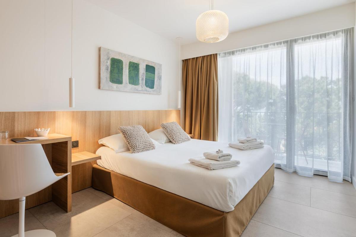 Un ou plusieurs lits dans un hébergement de l'établissement Grand Hotel Du Golfe - Spa & Restaurant