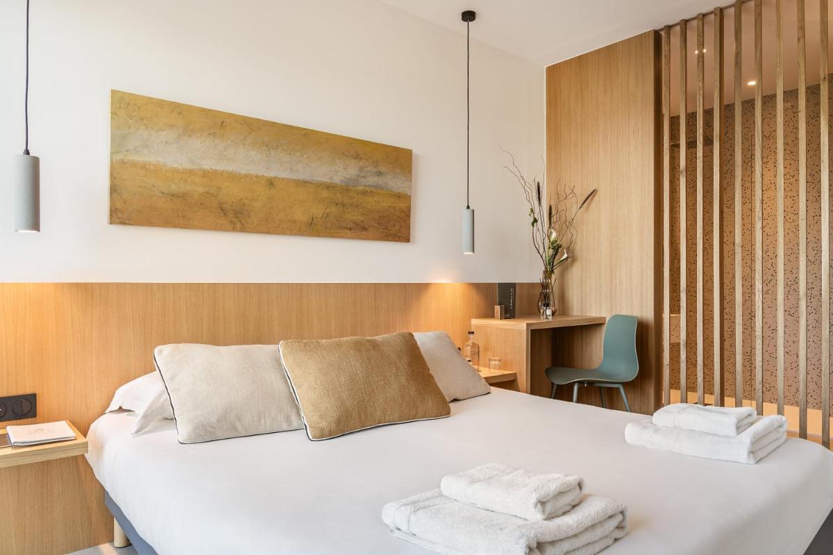 Un ou plusieurs lits dans un hébergement de l'établissement Grand Hotel Du Golfe - Spa & Restaurant