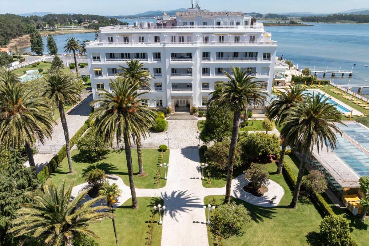 una vista aérea de un gran edificio blanco con palmeras en Eurostars Gran Hotel La Toja, en Isla de la Toja