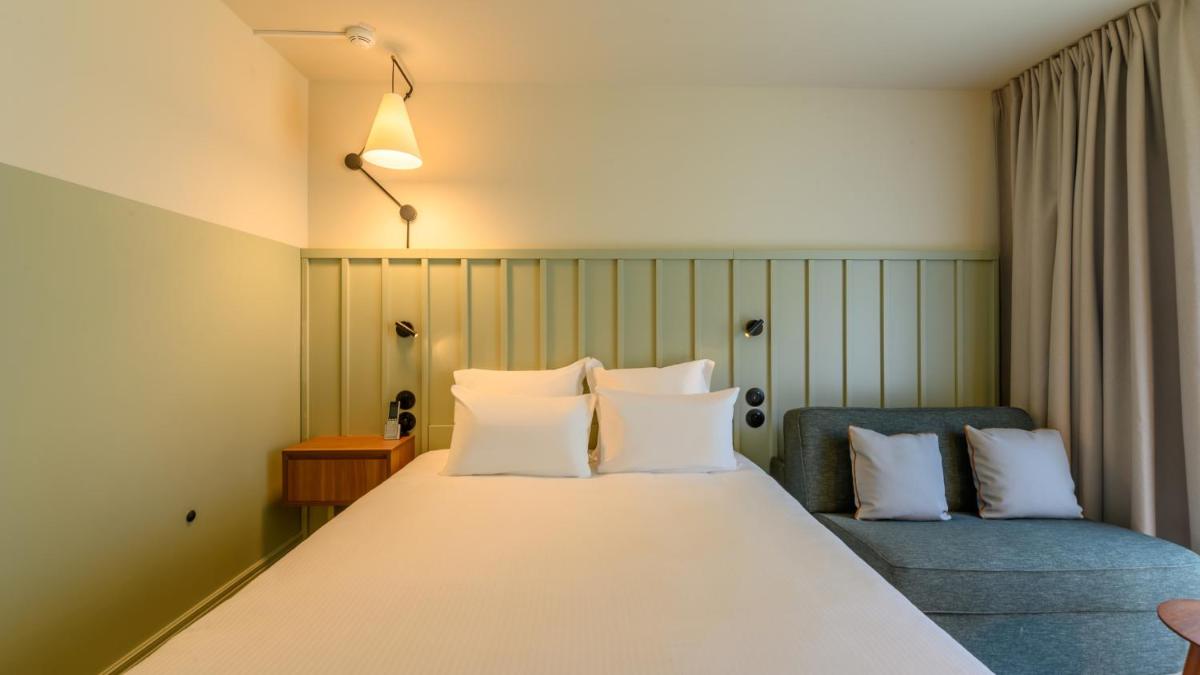 Un ou plusieurs lits dans un hébergement de l'établissement Kyriad Prestige Compiègne Hotel & Spa