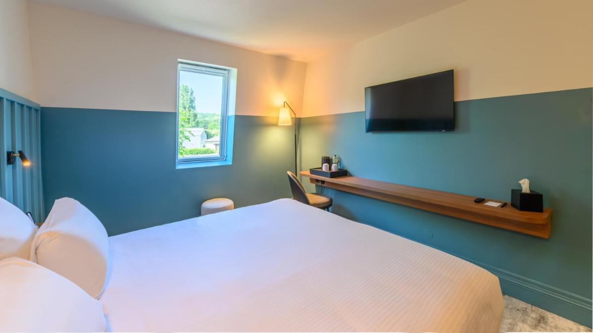 Un ou plusieurs lits dans un hébergement de l'établissement Kyriad Prestige Compiègne Hotel & Spa